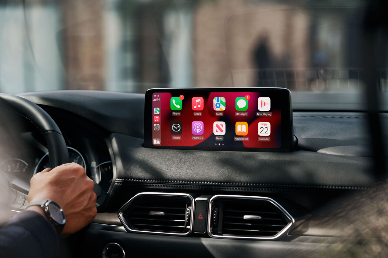 La descripción de Apple CarPlay de Mazda Canadá dice "desbloquear el